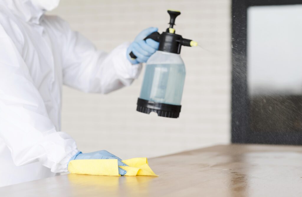 close-up-man-holding-disinfectant-bottle